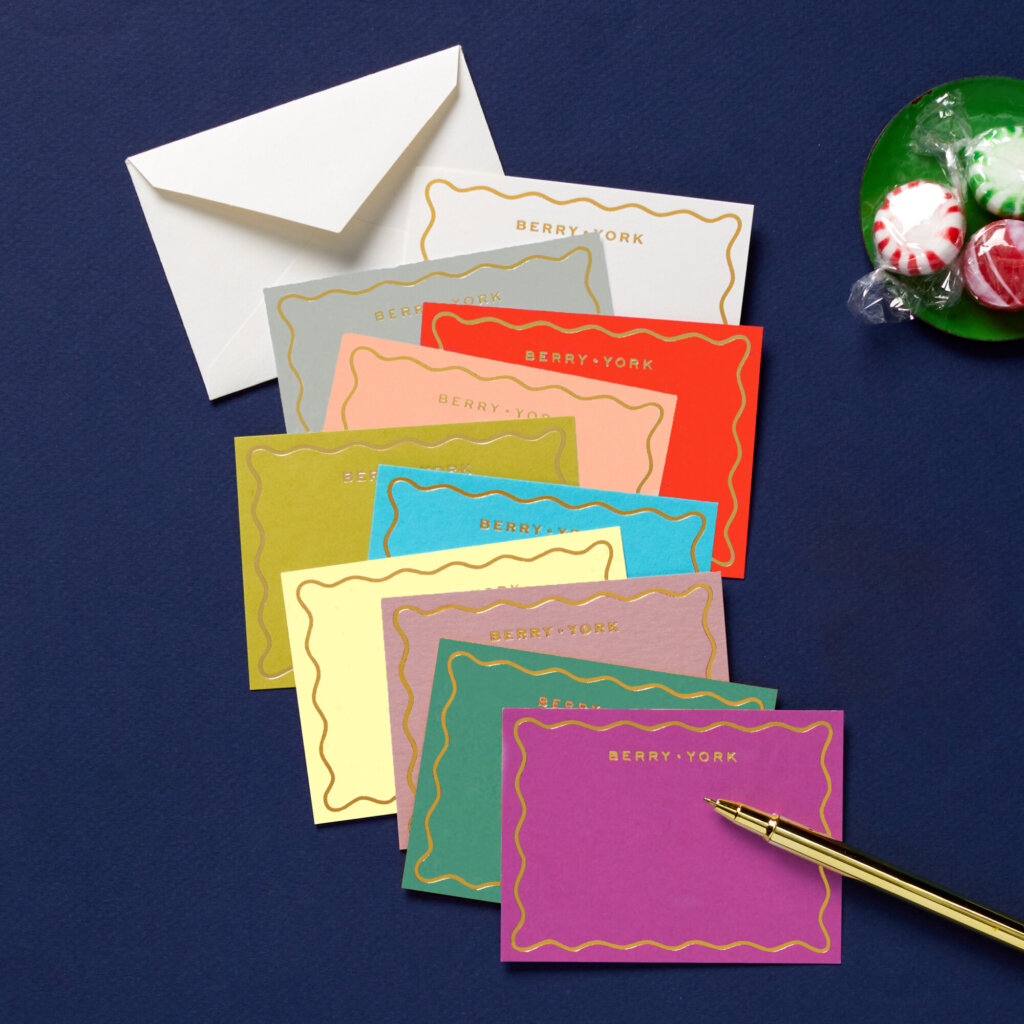 miniature foil-stamped gift enclosure cards from Cheree Berry Paper & Design in assorted colors spread out with matching envelope